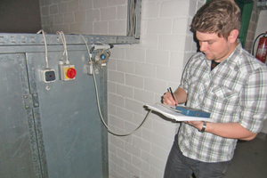  Tobias Thiel bei der Messung des statischen Drucks hinter einem Abluftventilator 